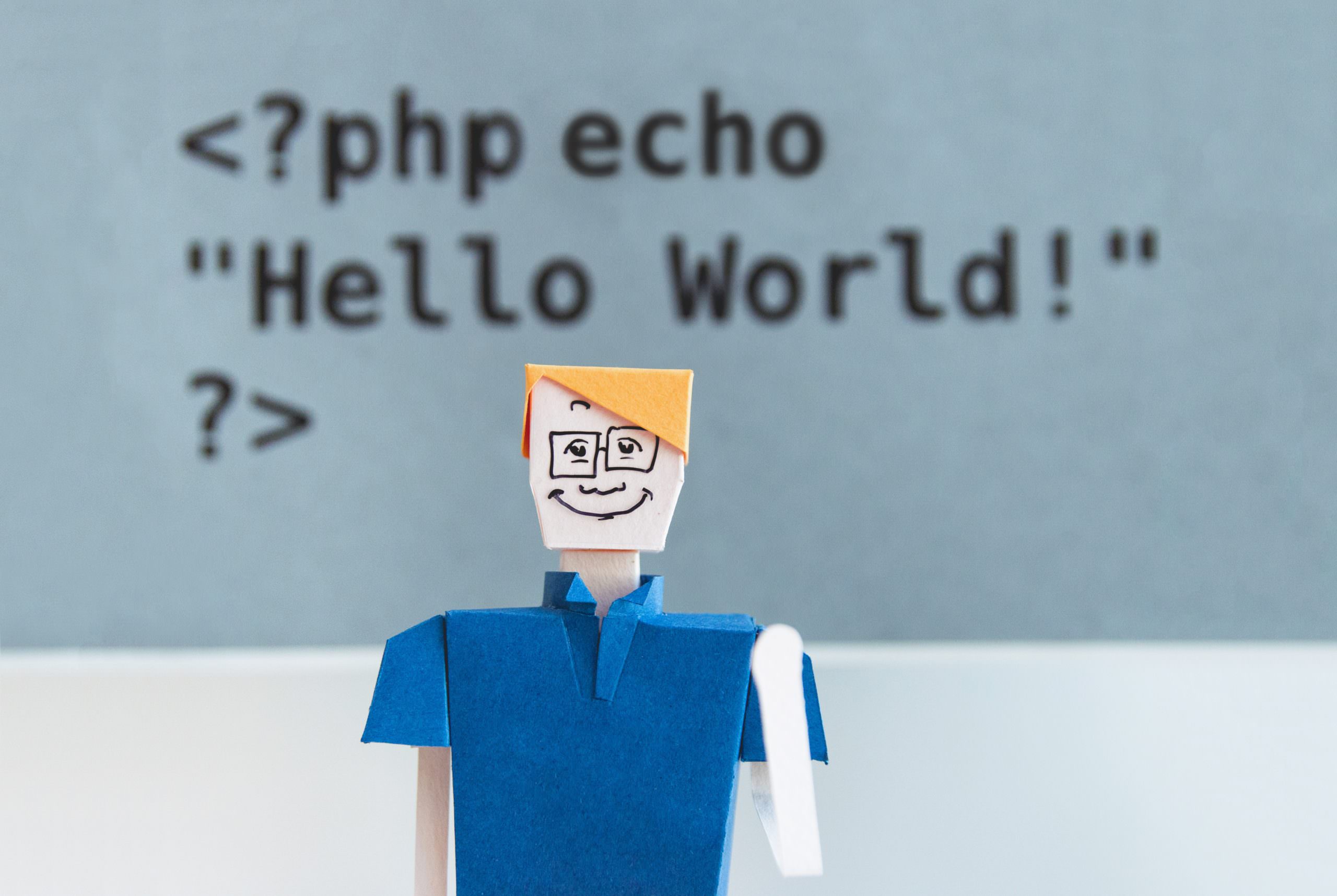 paper figure in front of coding text