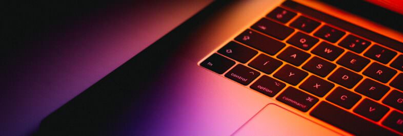 colorful photo of macbook pro with dark background